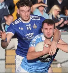  ??  ?? Naomh Mairtín’s Sam Mulroy takes down Ian Connor of Newtown Blues during Sunday’s Louth SFC final in Drogheda.