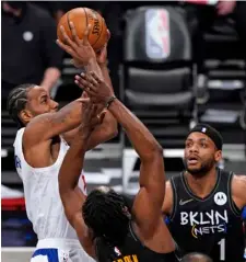  ?? AP Photo/Kathy Wilens ?? Los Angeles Clippers forward Kawhi Leonard (2) shoots over Brooklyn Nets guard James Harden (13) as Nets guard Bruce Brown (1) and forward Kevin Durant (7) watch during the second quarter of an NBA basketball game on Tuesday in New York.