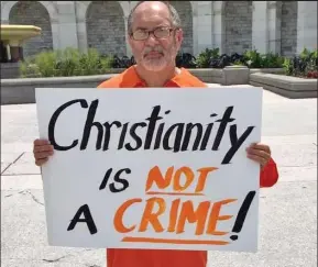  ??  ?? Christian campaigner: Rev Patrick Mahoney holds a placard protesting against the jailing of a pastor in Iran