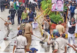  ?? — PTI ?? Police personnel lathicharg­e Congress activists to disperse them during a protest rally in Indore on Wednesday.