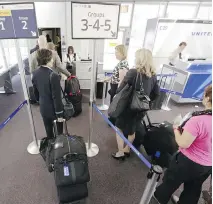  ?? ASSOCIATED PRESS FILES ?? The Internatio­nal Air Transport Associatio­n says many airlines have agreed to reduce the size of carry-on bags to optimize cabin storage space under new voluntary internatio­nal guidelines.