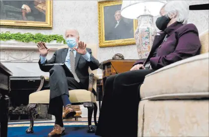  ?? Andrew Harnik The Associated Press ?? President Joe Biden, accompanie­d by Treasury Secretary Janet Yellen, speaks as he gets his weekly economic briefing Friday.