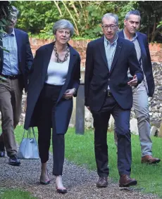  ?? EUROPEAN PRESS AGENCY ?? British Prime Minister Theresa May attends St. Andrews Church with her husband Phillip. Under heavy criticism, May named a new cabinet Sunday.