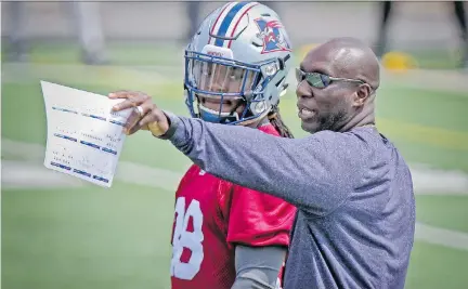  ?? JOHN MAHONEY/MONTREAL GAZETTE ?? Alouettes special teams co-ordinator Kavis Reed, shown talking to defensive back Dominique Ellis during practice last week, says his unit’s costly miscue in Friday’s 25-23 road loss to the Blue Bombers in Winnipeg was “a simple block that we didn’t...