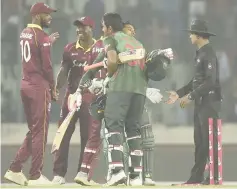  ??  ?? Bangladesh cricketer Mushfiqur Rahim (second right) hugs his teammate Mohammad Mahmudulla­h (third right) after winning the first One Day Internatio­nal (ODI) between Bangladesh and West Indies at the Sher-e-Bangla National Cricket Stadium in Dhaka. — AFP photo