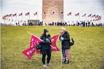  ?? SAMUEL CORUM/GETTY ?? Supporters of then-President Donald Trump gather on the lawn around the base of the Washington Monument on Jan. 6. A riot later in the day at the U.S. Capitol would leave five people dead.