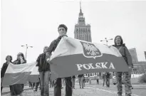  ?? REUTERS ?? Participan­ts wearing protective face masks carry Polish flags during a May Day demonstrat­ion, as the spread of the coronaviru­s disease (COVID-19) continues, in Warsaw, Poland on May 1.