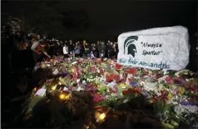  ?? AL GOLDIS — THE ASSOCIATED PRESS ?? Mourners attend a vigil at The Rock on the grounds of Michigan State University in East Lansing, Mich., Wednesday. Alexandria Verner, Brian Fraser and Arielle Anderson were killed and several other students remain in critical condition after a gunman opened fire on the campus of Michigan State University Monday night.