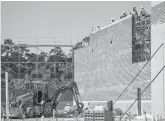  ?? Brett Coomer / Houston Chronicle ?? Workers build a portion of 336 Marketplac­e in the Grand Central Park developmen­t in Conroe.