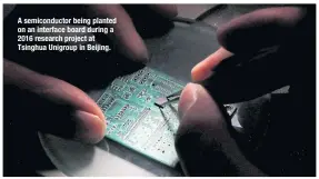  ?? ?? A semiconduc­tor being planted on an interface board during a 2016 research project at Tsinghua Unigroup in Beijing.