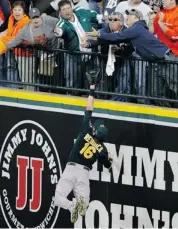  ?? DUANE BURLESON/THE ASSOCIATED PRESS ?? Athletics right fielder Josh Reddick reaches but is unable to catch a controvers­ial solo home run hit by Tigers DH Victor Martinez in the seventh inning of Game 4 on Tuesday.