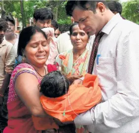  ??  ?? THIS PHOTOGRAPH taken on August 12, 2017, shows Dr Kafeel Khan along with relatives mourning the death of a child at the Baba Raghav Das Hospital in Gorakhpur, Uttar Pradesh.