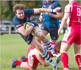  ??  ?? Returning Connor Stapley No.6 carries hard through Barum tackles