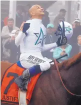  ?? STEVE HELBER/ASSOCIATED PRESS ?? New Mexico native Mike Smith exults after riding Justify to victory in the Preakness. It was Smith’s third Preakness victory.