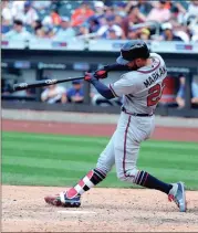  ?? FRANK FRANKLIN II / The Associated Press ?? Atlanta’s Nick Markakis connects for a solo homer in the 10th inning on Sunday.