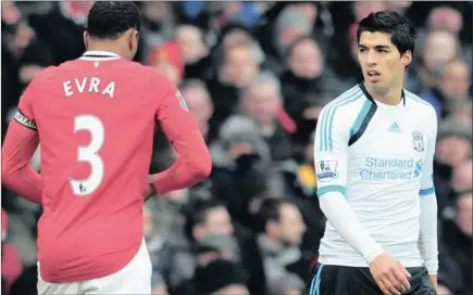  ??  ?? Patrice Evra, left, and Luis Suarez on his return after serving an eight-match ban for racially abusing Evra during the Premier League match between Manchester United and Liverpool at Old Trafford last February. The Uruguayan striker refused to shake...