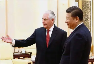  ?? AFP ?? Good
meeting: Xi and Tillerson at the Great Hall of the People in Beijing. —