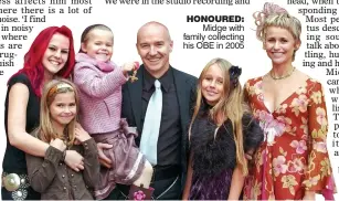  ??  ?? HONOURED: Midge with family collecting his OBE in 2005