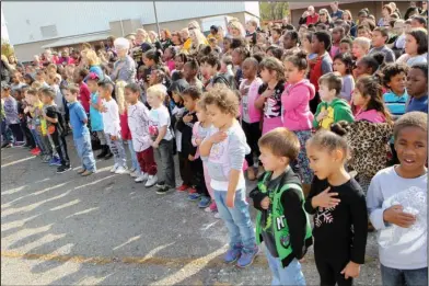  ?? The Sentinel-Record/Richard Rasmussen ?? TROJAN PRIDE: Students of Langston Aerospace and Environmen­tal Studies Magnet School say the Pledge of Allegiance Monday during a groundbrea­king ceremony for the future site of the school. The new alignment of the Hot Springs School District will extend the elementary magnet schools through sixth grade instead of the fourth grade.