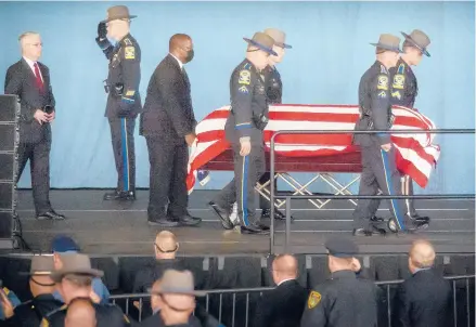  ?? MARK MIRKO/HARTFORD COURANT ?? The casket of Connecticu­t State Police Sgt. Brian Mohl is transporte­d across the stage of Xfinity Theatre in Hartford during funeral services for Mohl, a 26-year Connecticu­t State Police veteran who died Sept. 2 during flooding from Hurricane Ida while on duty in Woodbury.