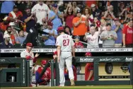  ?? DAVID J. PHILLIP — THE ASSOCIATED PRESS ?? Phillies pitcher Aaron Nola is cheered as he walks off the mound in the seventh inning Monday night. Nola was perfect for 6.2innings as he got the Phillies going toward a playoff-clinching 3-0win over Houston Monday night for the team’s first playoff berth since 2011.