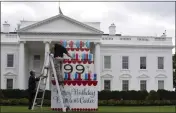  ?? MANUEL BALCE CENETA — THE ASSOCIATED PRESS ?? Workers work on a wooden cake display on the North Lawn of the White House on Saturday, in honor of former President Jimmy Carter's 99th birthday today.