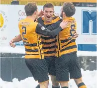  ??  ?? Alloa’s Innes Cameron (centre) celebrates his late equaliser against Arbroath