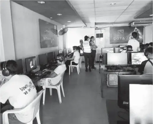  ??  ?? AUTHORITIE­S conduct inspection in an internet café in barangay Carmen on Thursday, November 8, where 6 minors were rescued. (PJ Orias)