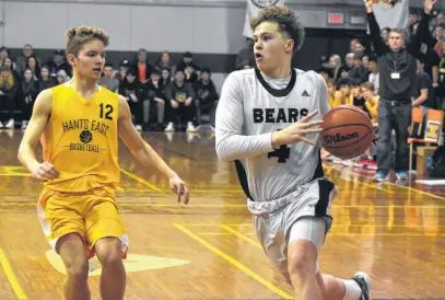  ?? JEREMY FRASER • CAPE BRETON POST ?? Cohen McDonald of the Breton Education Centre Bears, right, works his way up the court as he’s chased by Kasey Cox of the Hants East Tigers during the New Waterford Coal Bowl Classic championsh­ip game at BEC gym in New Waterford on Saturday. BEC won the game 111-91 to win their second consecutiv­e Coal Bowl title.