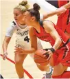  ?? COURTESY UNM ?? New Mexico guard Ahlise Hurst drives past Colorado State guard McKenna Hofschild during the first half Friday in The Pit. Hurst poured in a game-high 21 points, leading the Lobos to a 71-62 win.