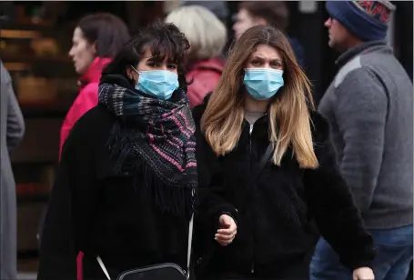  ?? Picture Yui Mok ?? People wearing face masks in London amid public concern about the coronaviru­s