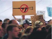  ?? AFP ?? A man displays an anti-gun violence sign during a March for our Lives rally in Newtown, Connecticu­t