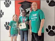  ??  ?? Addy Smith and Jakhiya Johnson stand with Northside teacher Joshua Bearden after the pair earned a win in a stock market trading game.