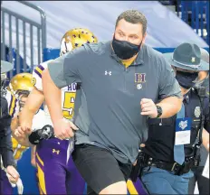  ?? MICHAEL GARD / POST-TRIBUNE ?? Hobart coach Craig Osika takes the field with the Brickies during the Class 4A state final.