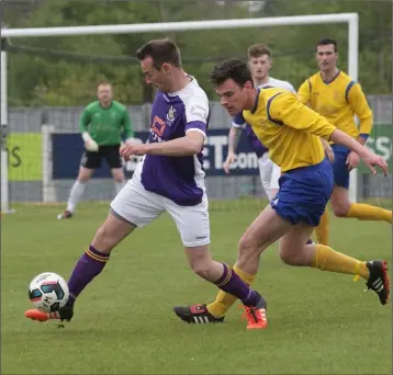  ??  ?? Wexford’s Lee Wadding-Byrne is tracked by Niall Whelan of the Clare Football League.