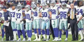  ?? MICHAEL CHOW/AZCENTRAL SPORTS ?? Dallas Cowboys players link arms for the national anthem before the Monday Night Football game at University of Phoenix Stadium in Glendale.