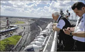  ?? AP FILE ?? Team owner Roger Penske (left), watches from the roof of the grandstand­s before the 2015 Daytona 500. Penske is to be inducted into the NASCAR Hall of Fame tonight.