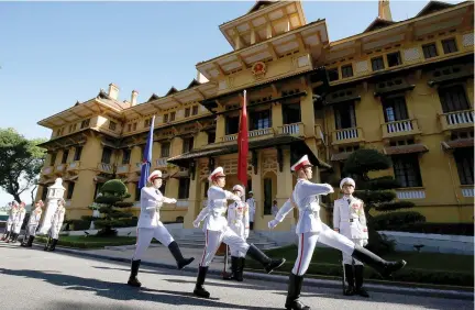  ??  ?? HONOR GUARDS march past the Associatio­n of Southeast Asian Nations (ASEAN) flag and Vietnamese flag in the background, after a flag raising ceremony to mark the 50th anniversar­y of the regional group at Vietnam’s Ministry of Foreign Affairs in Hanoi,...