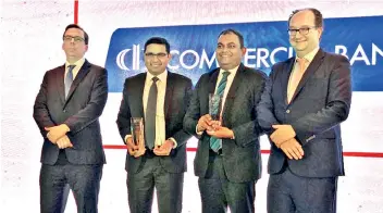  ??  ?? Commercial Bank Deputy General Manager Corporate Banking Sanath Manatunge and Deputy General Manager Marketing Hasrath Munasinghe (second and third from left) with Asiamoney awards won by the bank at the award ceremony in Hong Kong