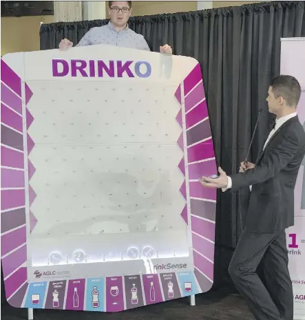  ?? SHAUGHN BUTTS ?? Games show-style host Tyler Rygus hosts the Alberta Gaming and Liquor Commission’s Plinko-like Drinko game with contestant Robyn Paches. The game is a part of the DrinkSense campaign.