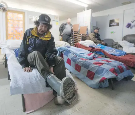  ?? LIAM RICHARDS ?? John James McKenzie, a client of the Scattered Site Outreach Program in La Ronge, prepares to go to sleep on a lounger at the shelter on April 21. Money to keep the shelter open overnight has dried up, leaving many to wonder what will happen to those without a place to go at night.