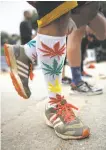  ?? Michael Macor / The Chronicle ?? Omar Cuevas of Castro Valley wears weed-themed socks.