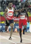  ?? PHOTO: REUTERS ?? Zharnel Hughes, of England, impedes Jereem Richards, of Trinidad and Tobago, during the men’s 200m final at Carrara Stadium on the Gold Coast on Thursday night.