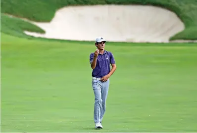  ?? AP Photo/David Dermer ?? ■ Joaco Niemann examines his ball on the 10th hole after picking Memorial golf tournament Friday in Dublin, Ohio. it at the start of a rain delay during the second round of the