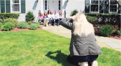  ?? John Kovach / Hearst Connecticu­t Media ?? Meghan Murphy Gould photograph­s the Schlafman family as part of the Front Steps Project in New Canaan on Saturday, April 25.