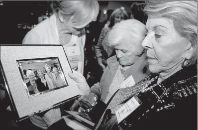  ??  ?? Georgiana Gunn holds a photo of “the Josettes,” an informal sisterhood centered on Josephine Smith,
who, along with her parents, Harrow and K.C., were given the President’s Award