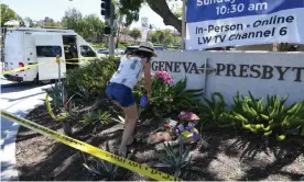  ?? Photograph: Robyn Beck/AFP/Getty ?? A woman places flowers at a makeshift memorial outside the Taiwanese Presbyteri­an church in Laguna Woods, California, on Monday.