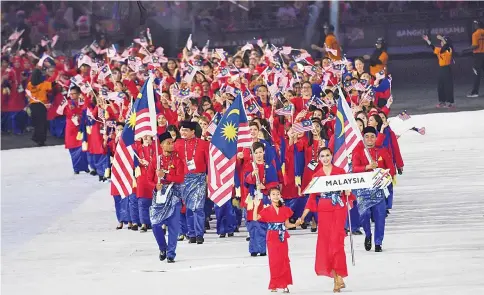  ?? — AFP photo ?? Athletes and officials of Malaysia march during the opening ceremony of the 29th Southeast Asian Games (SEA Games) in Kuala Lumpur on August 19, 2017.
