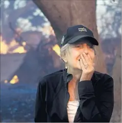  ?? Irfan Khan Los Angeles Times ?? JUDY HOFMANN-SANDERS watches as the Creek fire consumes her home on McBroom Street in L.A.’s Shadow Hills neighborho­od on Tuesday.