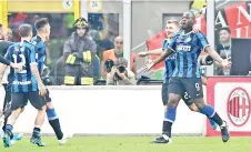  ??  ?? Inter Milan’s Belgian forward Romelu Lukaku (R) celebrates with teammates after scoring during the Italian Serie A football match AC Milan against Inter Milan. - AFP photo